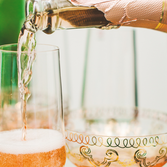 Sparkling Rosé poured into wine glasses. 